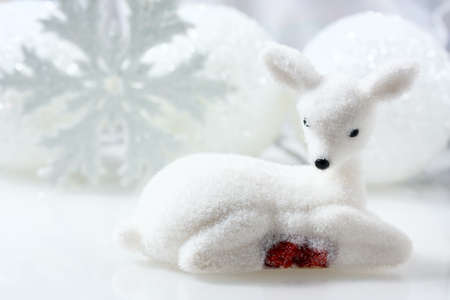 Small white deer and christmas decorations white background. copy space, soft focusの写真素材