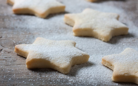 Homemade star shaped cookies on a wooden background. Christmas decoration. Selective focus