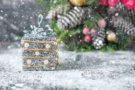Silver and white xmas ornaments on rustic wood background. Merry christmas card. Space for text. Selective focusの写真素材