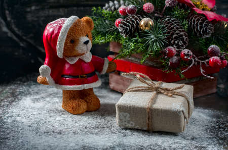 Santa Teddy Bear, Gift box wrapped linen cloth and decorated with linen cord, christmas decoration on brown vintage wooden boards background. Selective focusの写真素材
