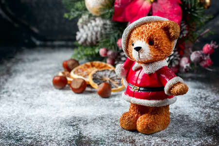 Santa Teddy Bear, Gift box wrapped linen cloth and decorated with linen cord, christmas decoration on brown vintage wooden boards background. Selective focusの写真素材