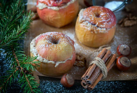 Baked apples with curd, honey and nuts baked in the oven, closeup. Selective focusの写真素材