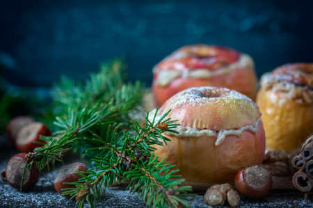 Baked apples with curd, honey and nuts baked in the oven, closeup. Selective focusの写真素材