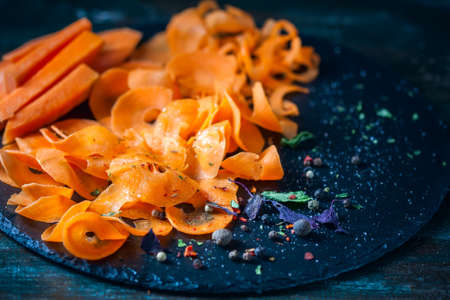 Close-up of grated carrots on dark background. Healthy diet and detox, selective focusの写真素材