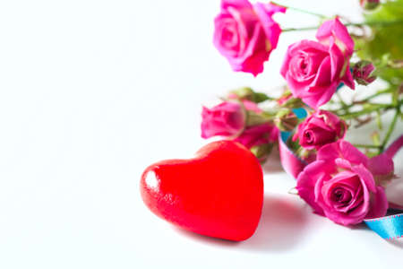 Kraft box and pink roses on white table, concept of Valentines Day, holiday. Selective focus. Red heart.の写真素材