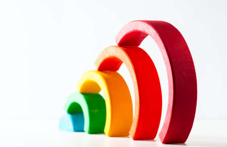 Rainbow, multicolored wooden eco toy. Isolated on whiteの写真素材
