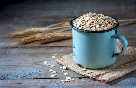 Oat flakes on a on wooden table, selective focus