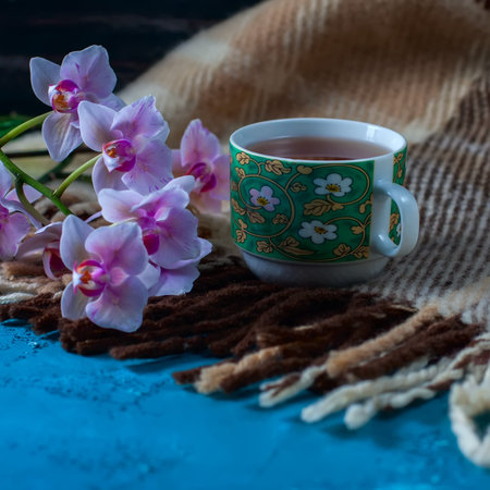 Cup of tea and warm knitted blanket. The concept of comfort. Selective focus