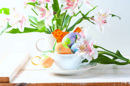 Easter eggs with spring flowers on table. Selective focusの写真素材