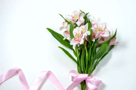 Bouquet of flowers alstroemeria with gift box on a white background. Selective focusの写真素材