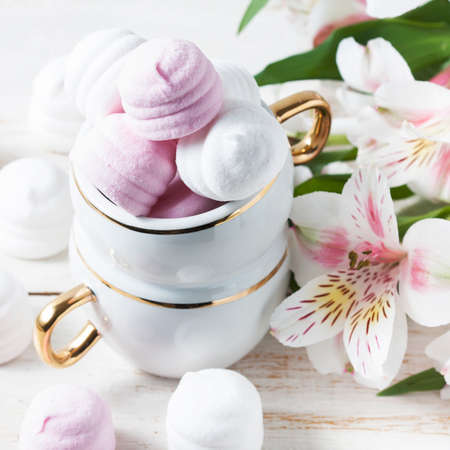 Delicious white and pink marshmallows in cup. Selective focusの写真素材