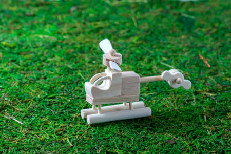 Wooden toys - a helicopter and a rainbow on the grass. selective focusの写真素材