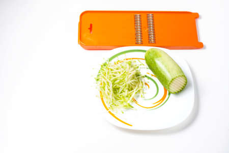 Grater and grated zucchini. Selective focusの写真素材