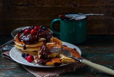 Pancakes with berries and chocolate sauce, selective focus