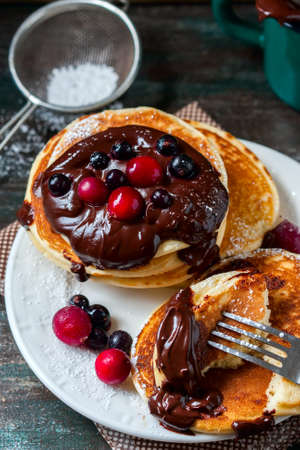 Pancakes with berries and chocolate sauce, selective focusの写真素材