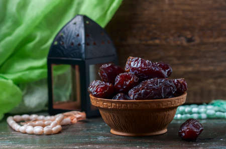 Dates fruit and rosary still life, on a dark wooden background. Selective focusの写真素材