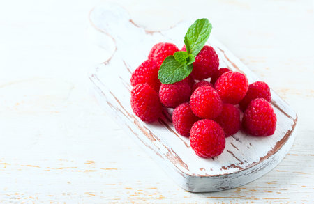 Ripe fresh raspberries on a wooden background. Selective focus