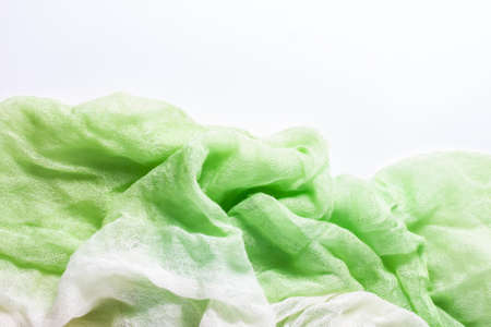 Bright green fabric folded to be used as background.の写真素材