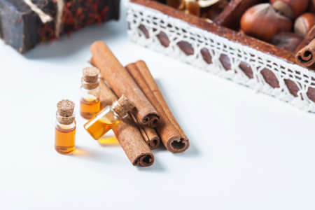 Essential oil cinnamon in glass bottle. Spa concept. Selective focus.の写真素材