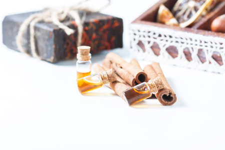 Essential oil cinnamon in glass bottle. Spa concept. Selective focus.の写真素材
