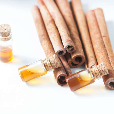 Essential oil cinnamon in glass bottle. Spa concept. Selective focus.の写真素材