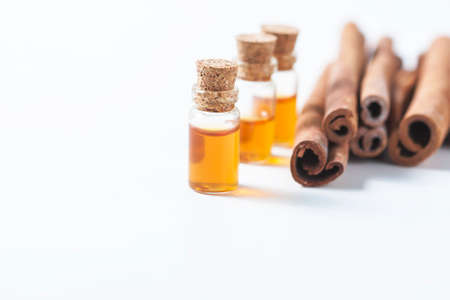 Essential oil cinnamon in glass bottle. Spa concept. Selective focus.の写真素材