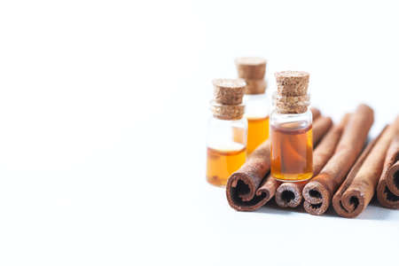 Essential oil cinnamon in glass bottle. Spa concept. Selective focus.の写真素材