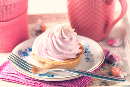 Beautiful and delicious breakfast concept. With cream cakes and cup of tea on vintage serving tray. Selective focusの写真素材