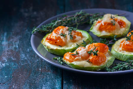 Baked zucchini with cherry tomatoes and cheese. Selective focusの写真素材
