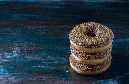Donuts with chocolate and nuts on a dark wooden background. Selective focusの写真素材