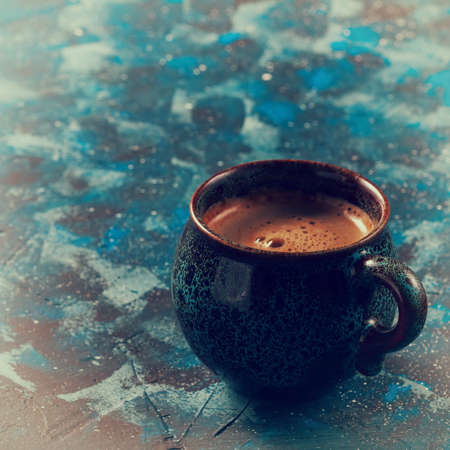 Blue coffee cup on dark blue backgroundの写真素材
