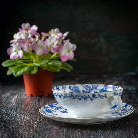 Vintage teacup and saucer, close up on a dark wooden background . Selective focusの写真素材