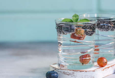 Carbonated drinks in glass with fresh berries. Selective focusの写真素材