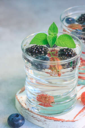 Carbonated drinks in glass with fresh berries. Selective focusの写真素材