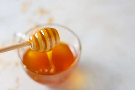 Natural honey with a wooden spoon.の写真素材