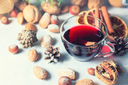 Christmas composition. Glass of red mulled wine on table with cinnamon sticks, Christmas decorations. Selective focusの写真素材