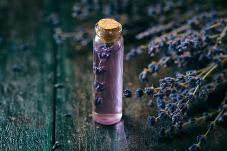 Concept spa therapy. Fresh lavender blossoms with Natural handmade lavender oil, sea salt. Selective focus.の写真素材