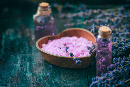 Concept spa therapy. Fresh lavender blossoms with Natural handmade lavender oil, sea salt. Selective focus.の写真素材