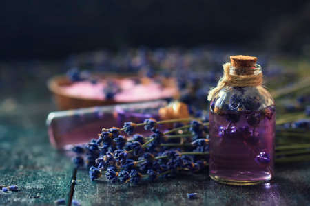 Concept spa therapy. Fresh lavender blossoms with Natural handmade lavender oil, sea salt. Selective focus.の写真素材