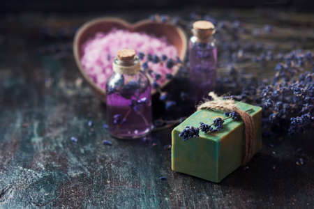 Concept spa therapy. Natural handmade soap, fresh lavender blossoms with Natural handmade lavender oil, sea salt. Selective focus.の写真素材