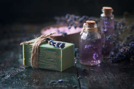 Concept spa therapy. Natural handmade soap, fresh lavender blossoms with Natural handmade lavender oil, sea salt. Selective focus.の写真素材