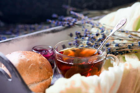 Wooden tray with cup of hot black tea with light breakfast. Breakfast concept.の写真素材