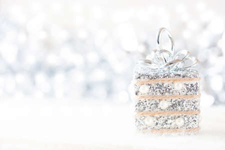Silver and white Christmas decorations on white snow background. Space for text. Selective focusの写真素材