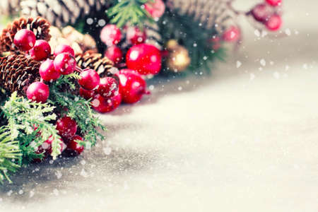 New Year and Christmas background. Christmas frame with decoration, sprig of pine, cones and berries. Place for text. Selective focusの写真素材