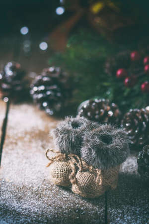 Christmas background with decorations on a Christmas tree handmade, winter boots. Soft focus.の写真素材