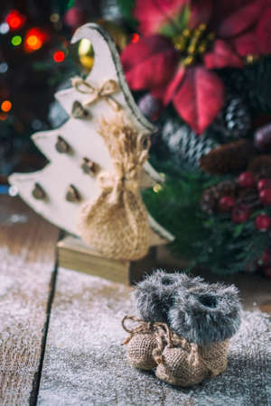 Christmas background with decorations on a Christmas tree handmade, winter boots. Soft focus. Festive still lifeの写真素材