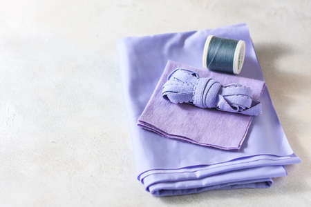 Everything for sewing. Beige fabric, sewing accessories and scissors. Seletive focusの写真素材