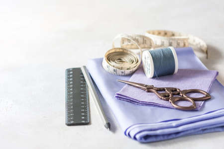 Everything for sewing. Beige fabric, sewing accessories and scissors. Seletive focusの写真素材