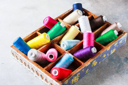 Bright multi colored embroidery thread yarns. Handmade embroidery sewing background. Selective focus