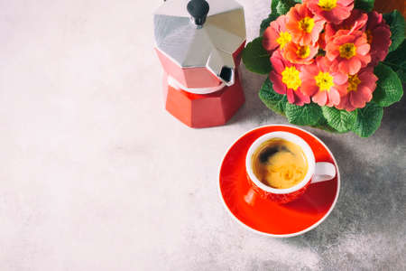 Close-up of hot coffee, moka-pot and flowers.の写真素材